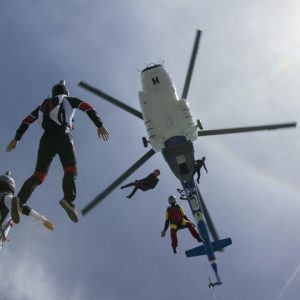 low-angle-view-of-helicopter-and-six-skydivers-free-falling-siofok-somogy-hungary.jpg